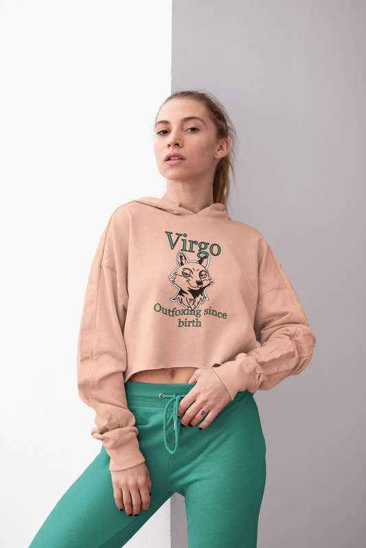 Blonde woman wearing a peach Bella + Canvas Virgo Outfoxing Since Birth cropped hoodie with teal sweatpants.