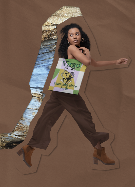 Woman walking with the Virgo Outfoxing Since Birth all-over print tote bag over her shoulder, showing the gold, green, and lavender geometric design.