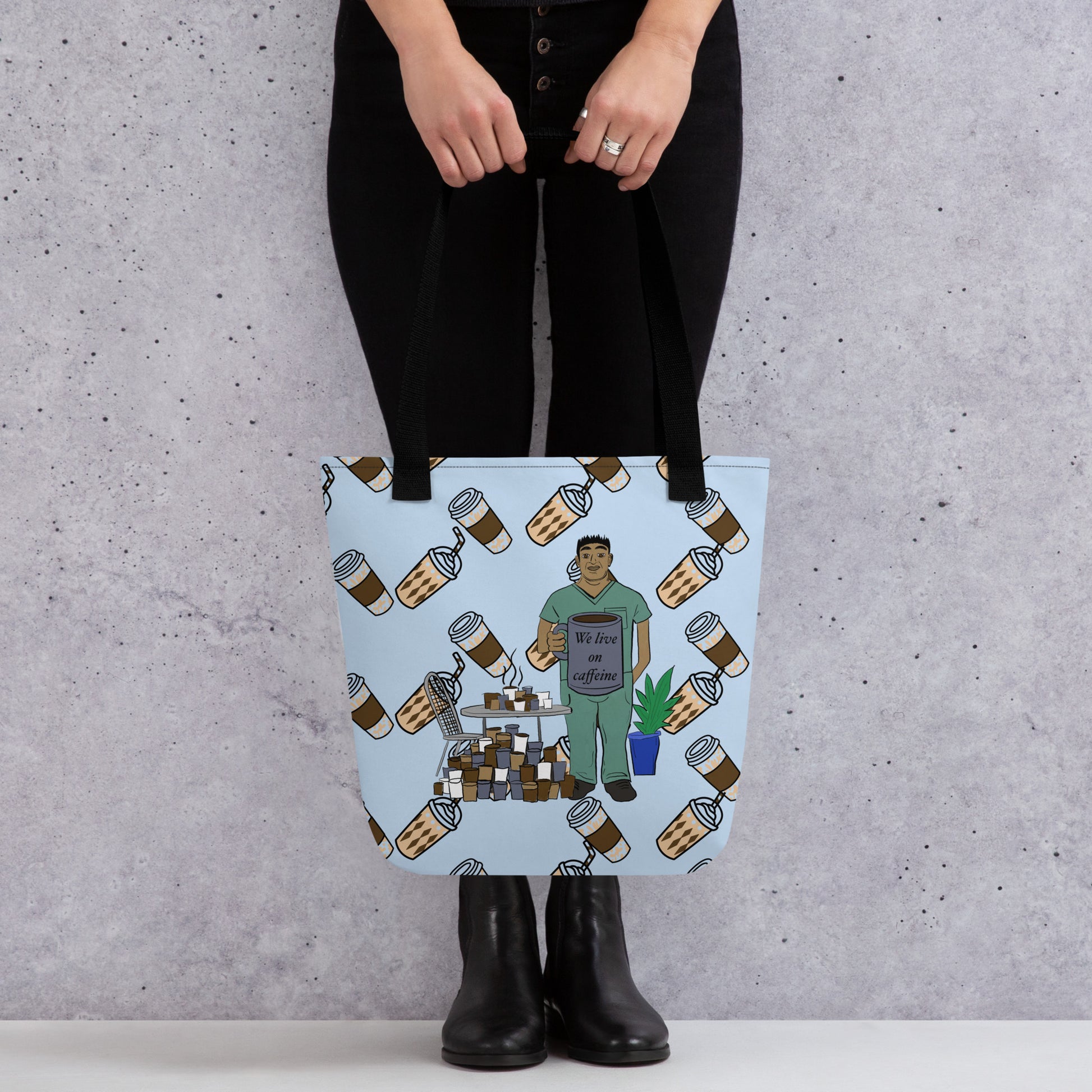 Person holding We Live on Caffeine all-over print tote bag with coffee cups and vet tech illustration – GrungePup Vet Chaos relatable vet tech gift