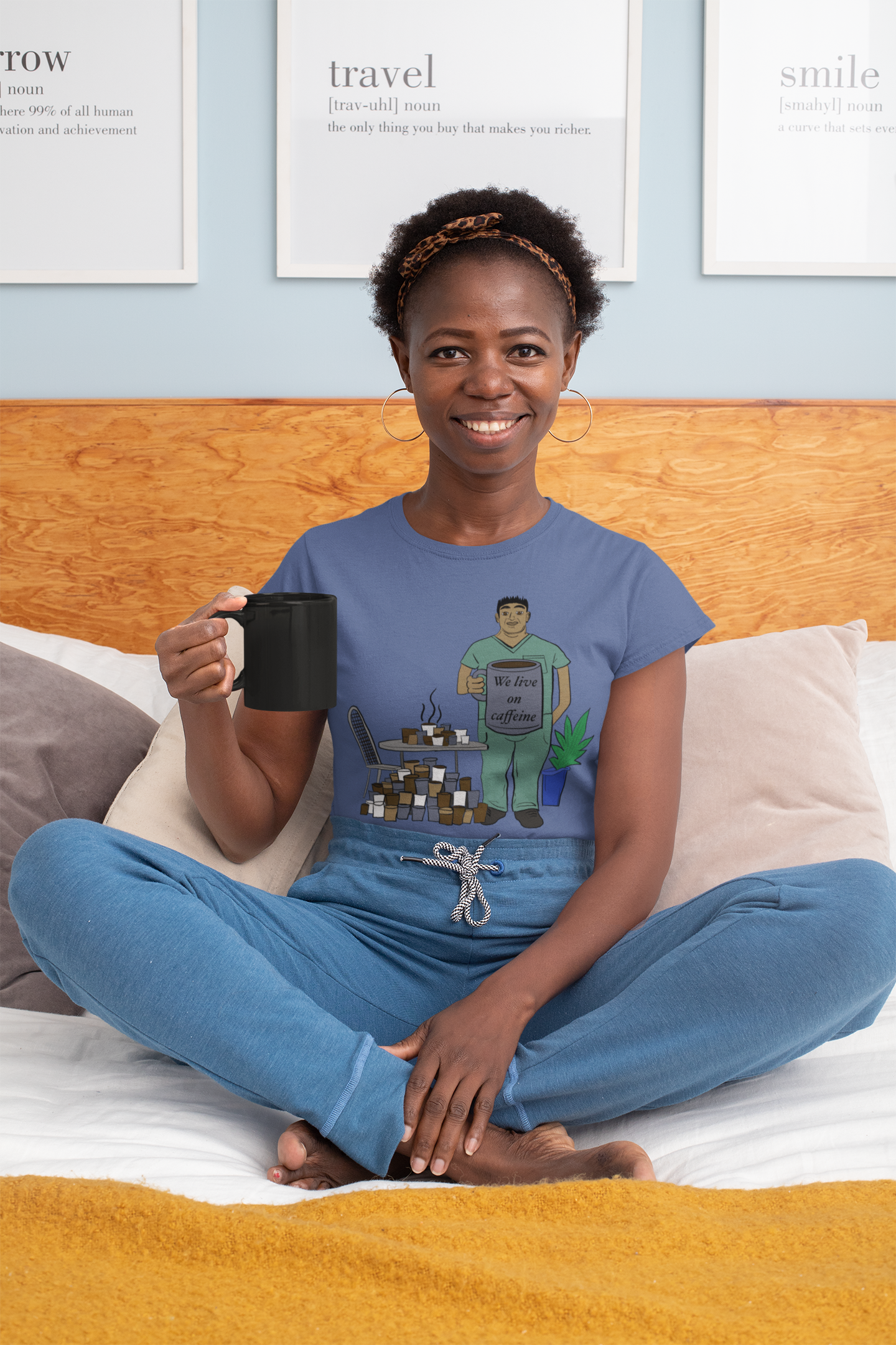 Black woman sitting on bed wearing heather true royal We Live on Caffeine t-shirt holding black coffee mug – funny vet tech apparel by GrungePup Vet Chaos