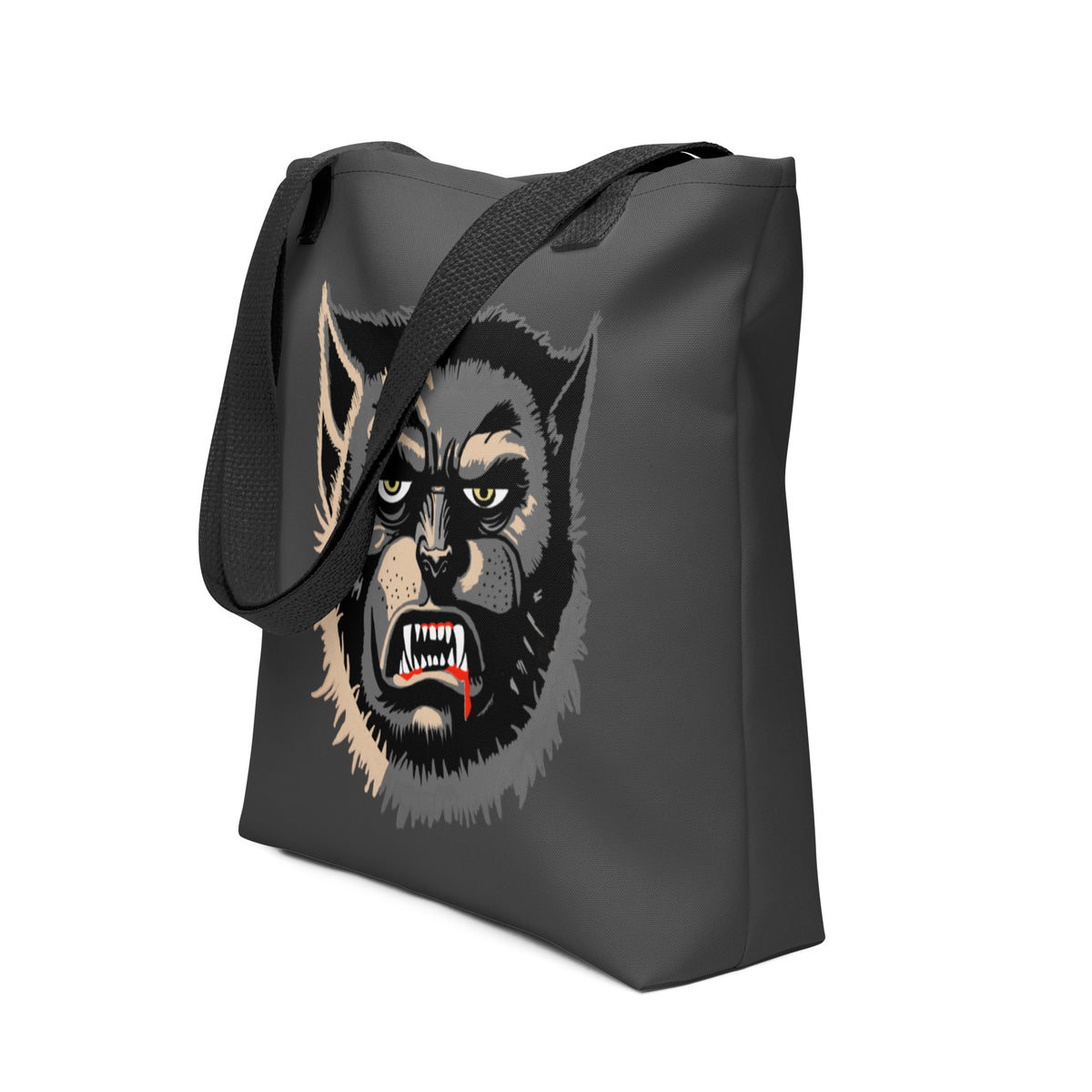 Side angle of the charcoal all-over print Wolfman tote bag with no model, black straps, face-only Wolfman design visible on the front panel