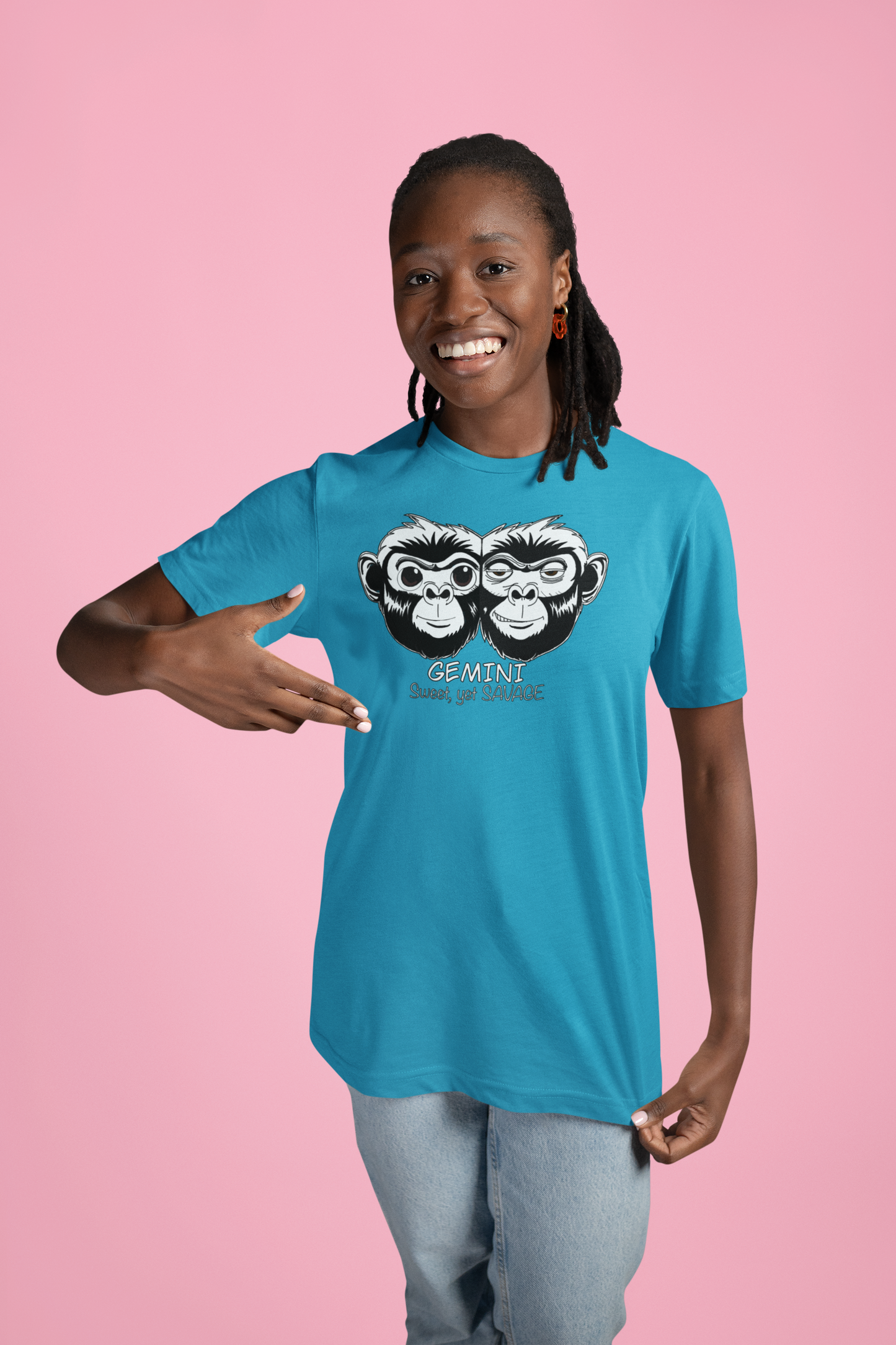 Black woman smiling while wearing a heather aqua Bella + Canvas t-shirt featuring the Gemini monkey design
