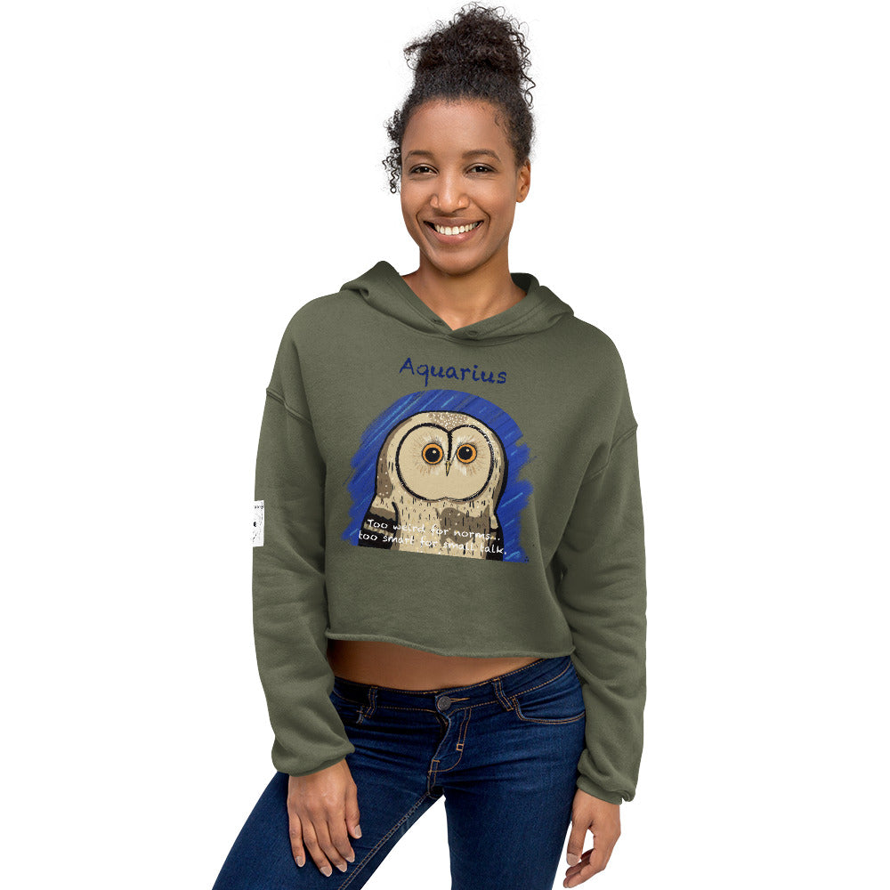 Woman standing in studio wearing a military green cropped hoodie with Aquarius owl zodiac artwork by GrungePup