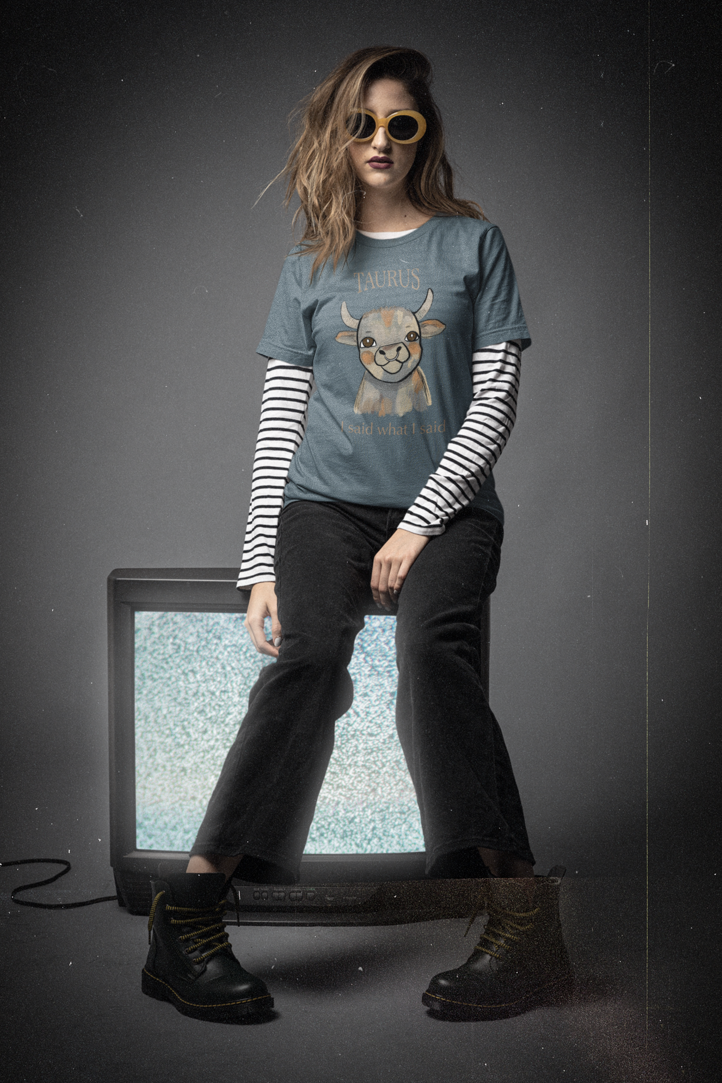 Woman with sunglasses and layered 90s grunge style wearing a heather slate Taurus Bull t-shirt