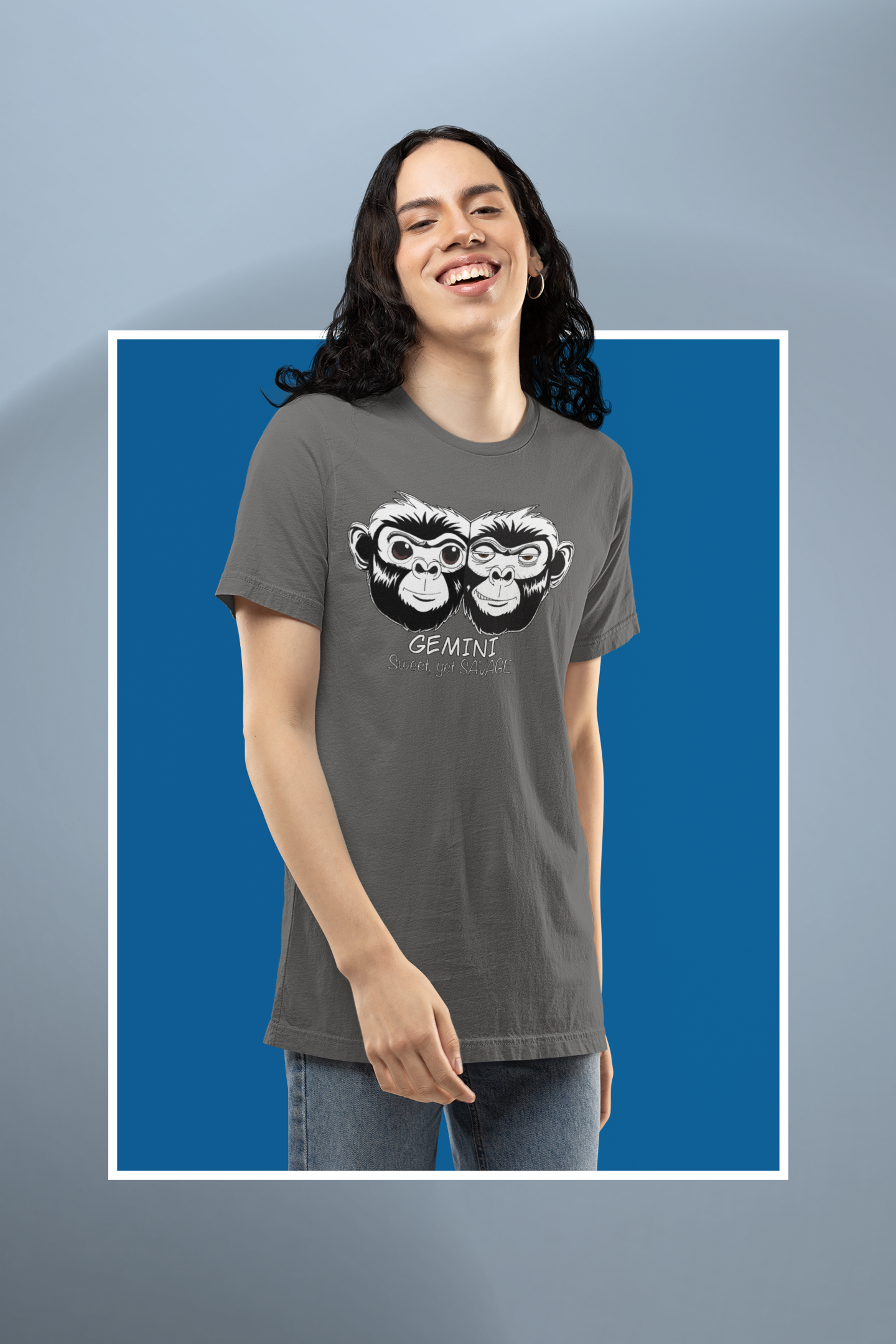 Woman standing against a blue background wearing an asphalt colored Gemini t-shirt