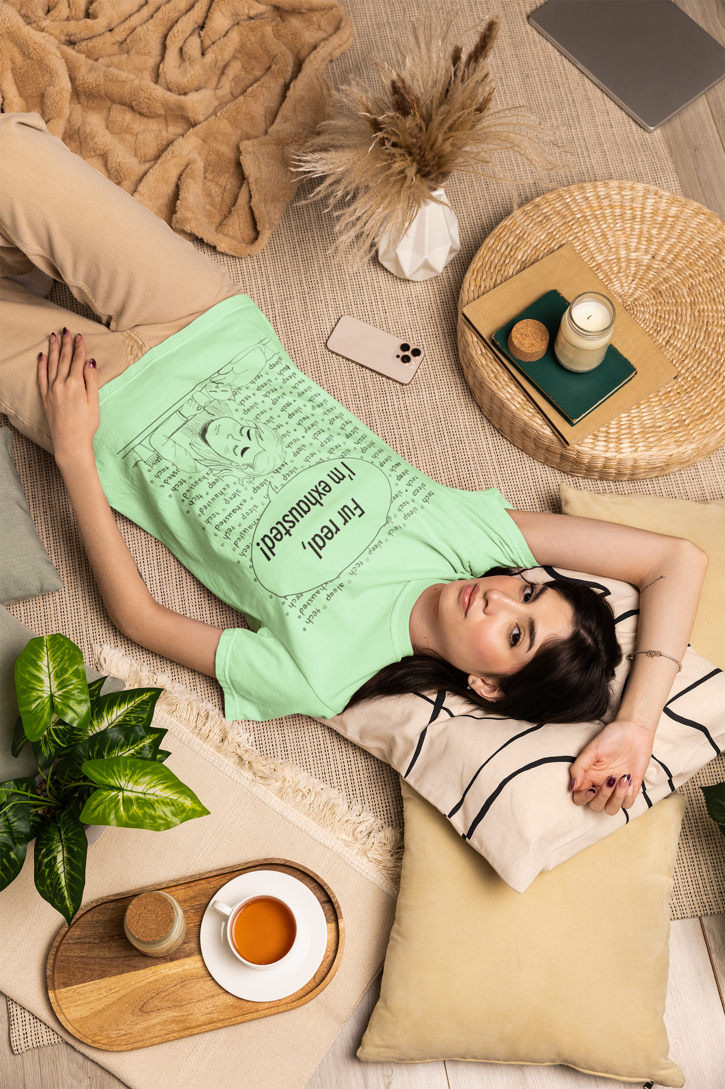 Woman with dark hair lying on the floor wearing an island reef green Fur Real, I'm Exhausted t-shirt