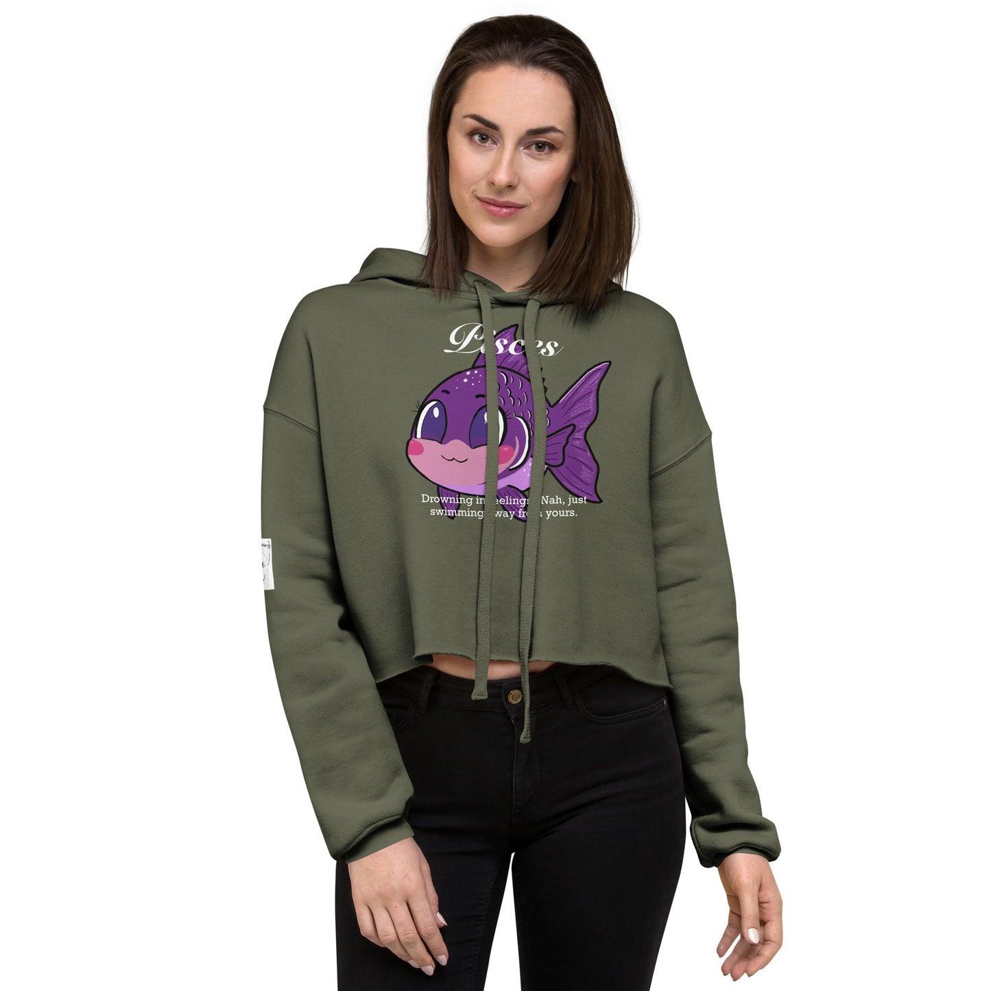 Woman standing against a light wall wearing a Military Green Pisces cropped hoodie