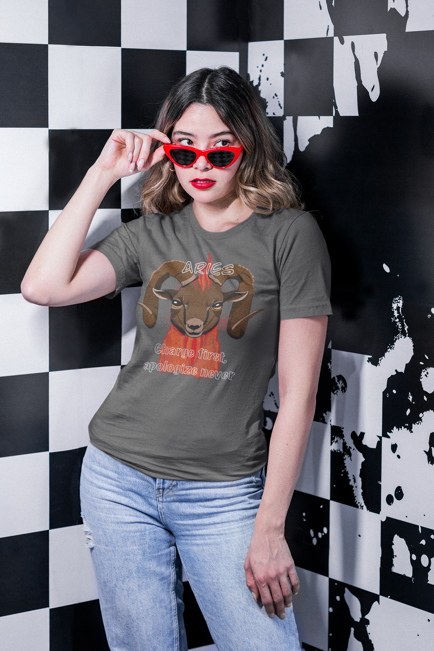 Woman with red sunglasses posing in front of black and white wall wearing an asphalt colored Aries ram t-shirt
