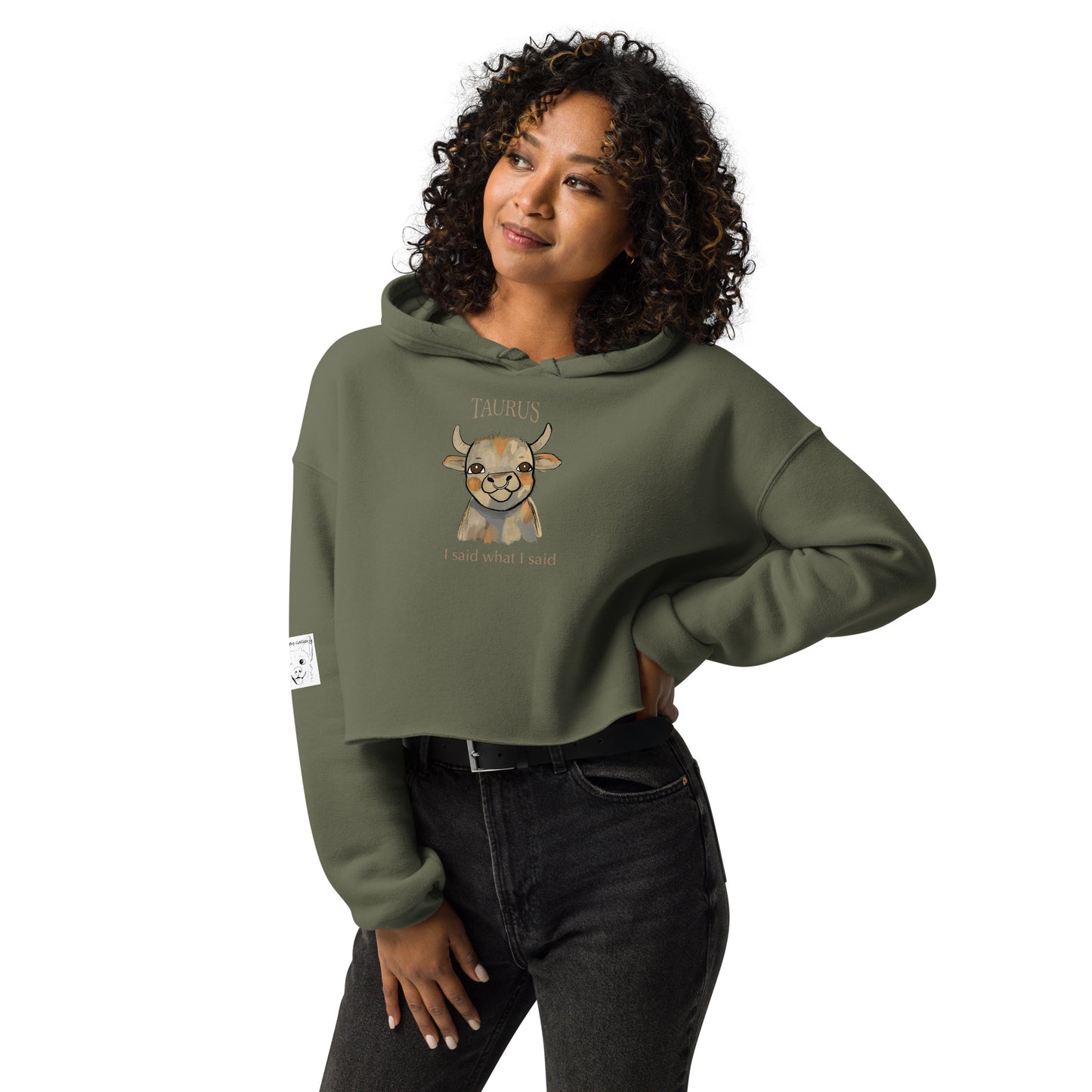 Woman with curly hair wearing a military green Taurus I Said What I Said cropped hoodie