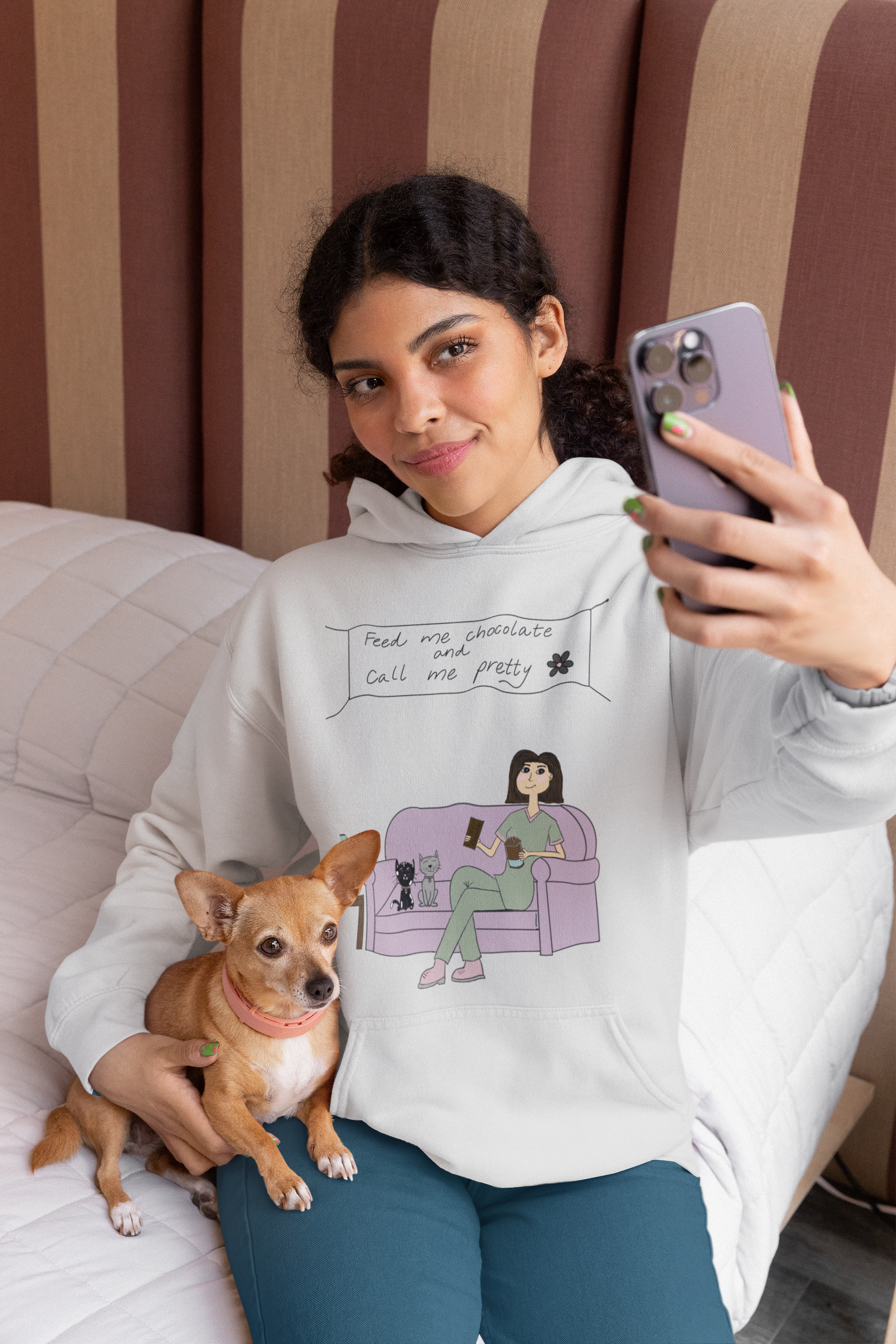 Woman sitting with her small dog wearing an ash grey Feed Me Chocolate and Call Me Pretty hoodie