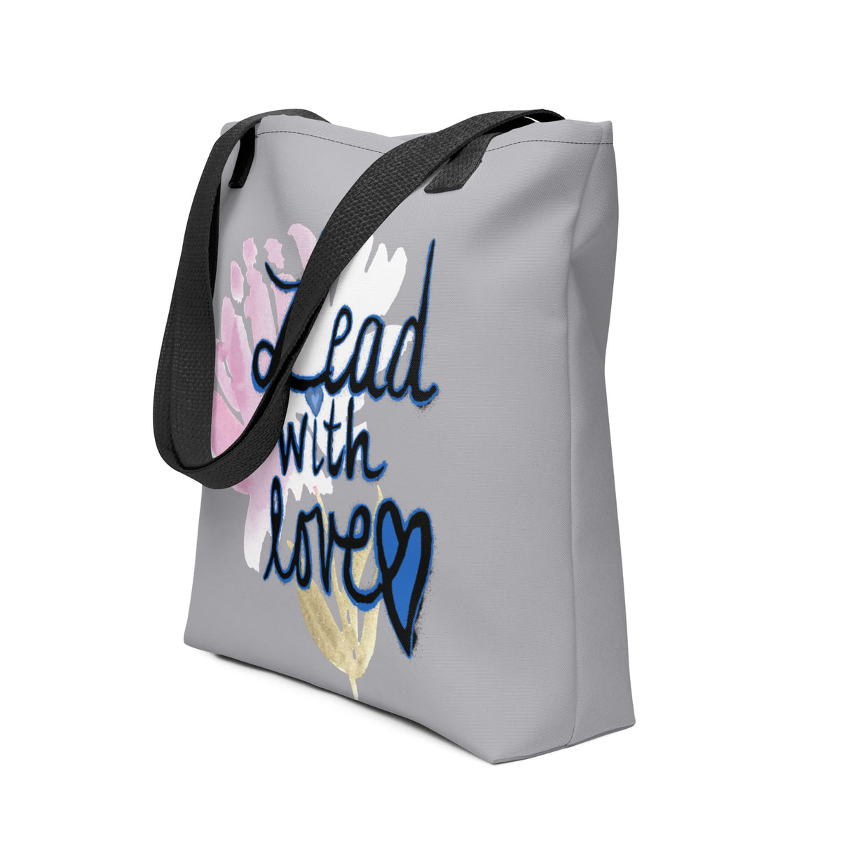 Side view of a grey canvas tote with black straps, showing the bag’s depth and the edge of the pink floral Lead with Love print.